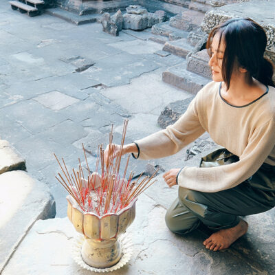 旅先にて、静かに線香を供えるクリス-ウェブ佳子さん